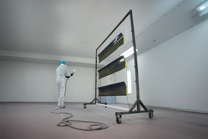 Technician applying clear coat to Verus Engineering rear wings