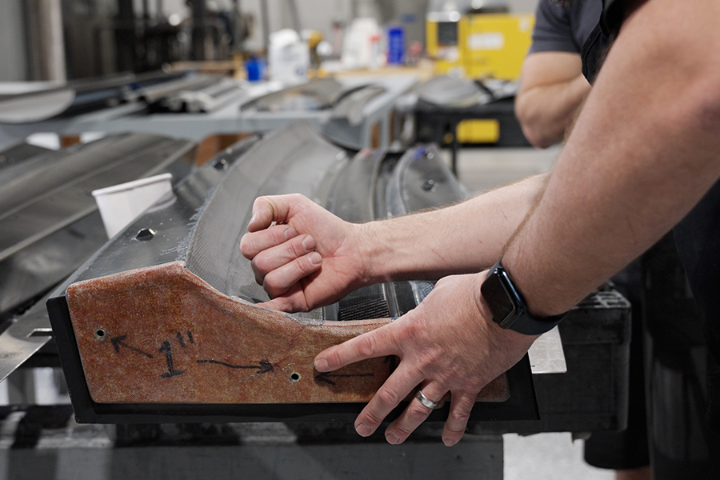 Verus Engineering technician working on a rear wing