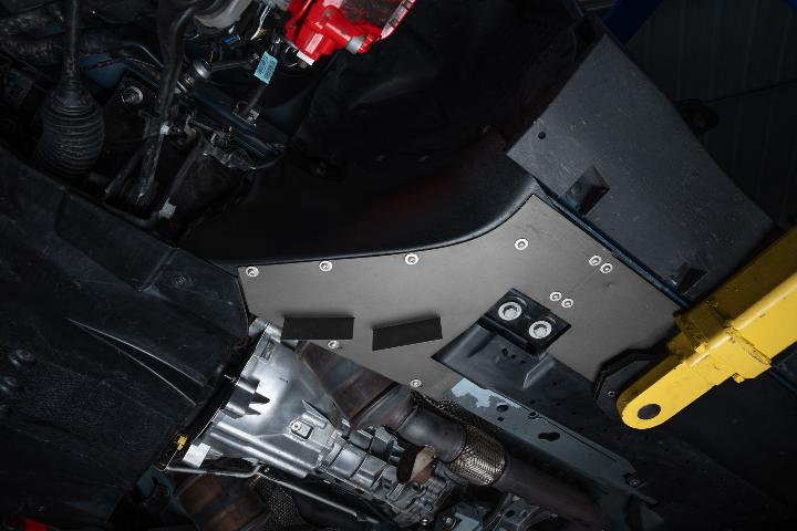 flat underbelly of a car displaying turning vanes