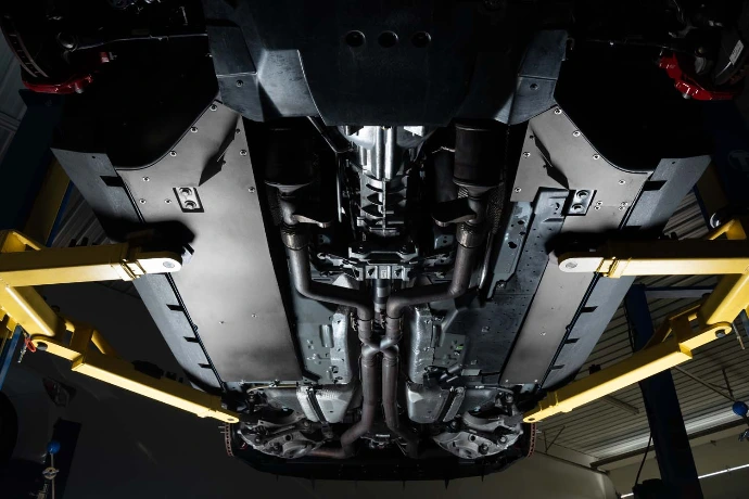 Underside of a Ford Mustang Shelby GT350 on a lift with the Verus Flat Underbody Panel Kit installed