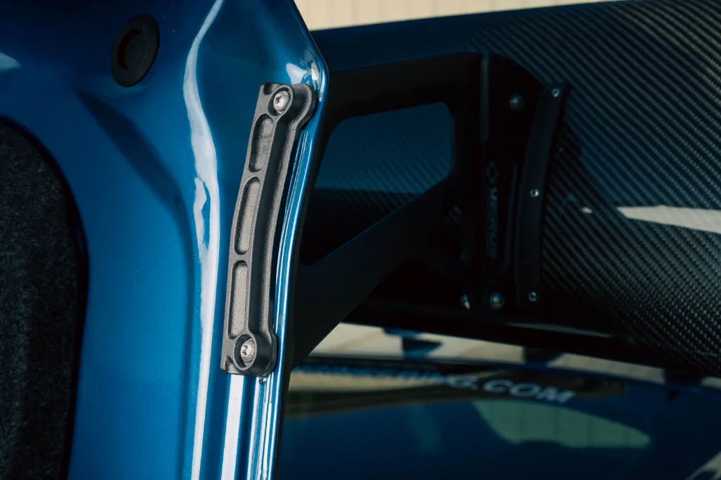 Dogbone support plate installed under the UCW Rear Wing upright on a Shelby GT350R